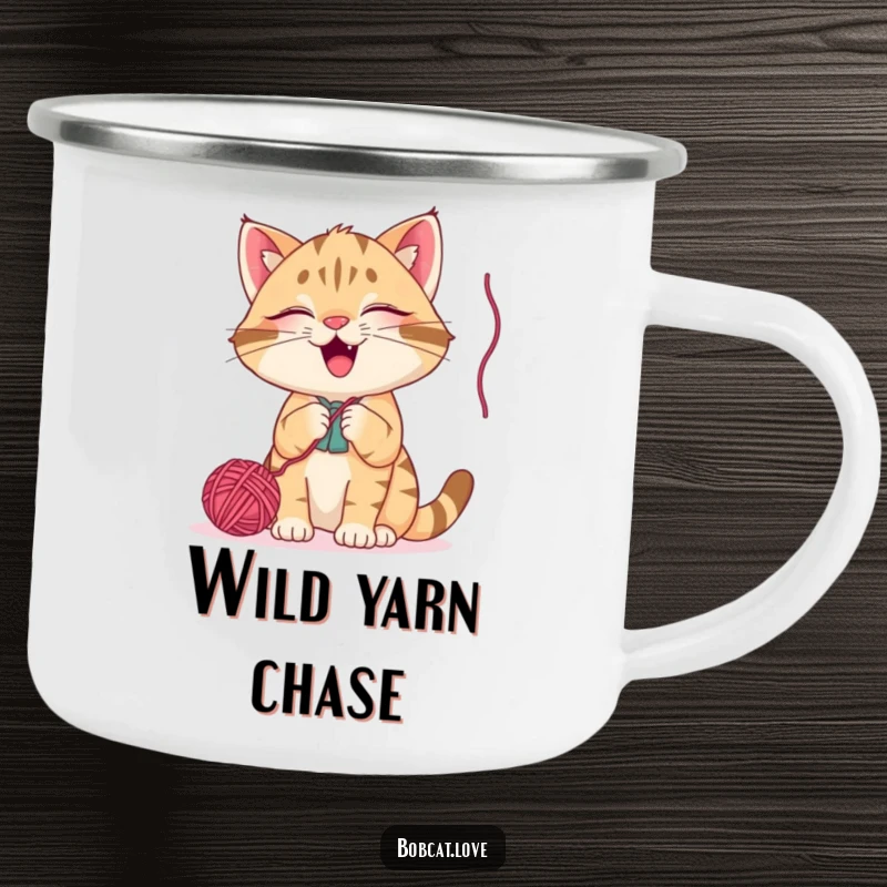 Funny bobcat camping mug, a happy cat batting at a dangling yarn ball, perfect for outdoor enthusiasts who love cats and humor.